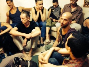 Inside shelter, Ian Robinson with hand on wrist, photo by Batsheva dancer Shamel Pitts